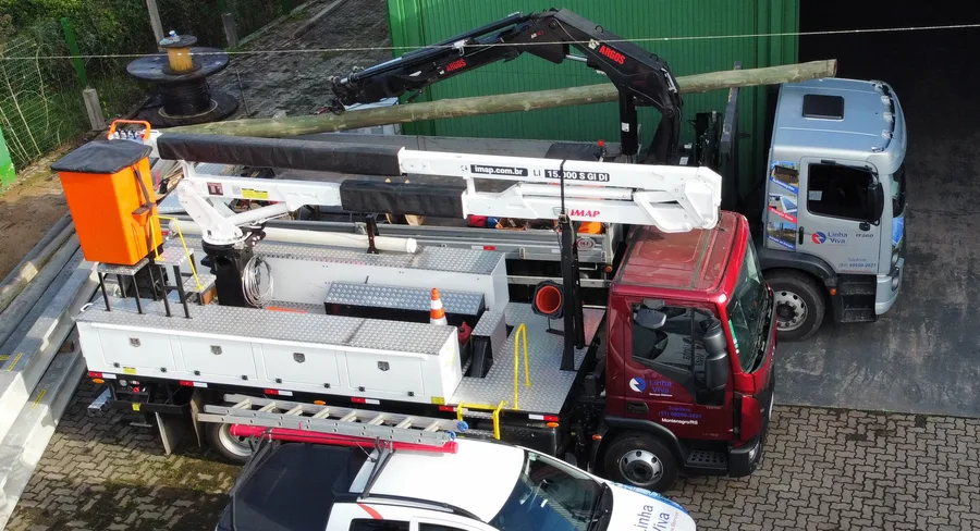 Detalhe dos caminhões com cesto aéreo e guindaste na sede do Grupo Linha Viva