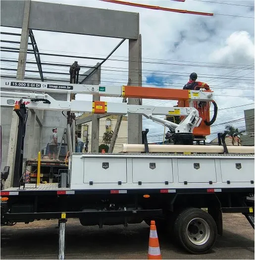 Caminhão com cesto aéreo junto a uma estrutura de entrada de energia