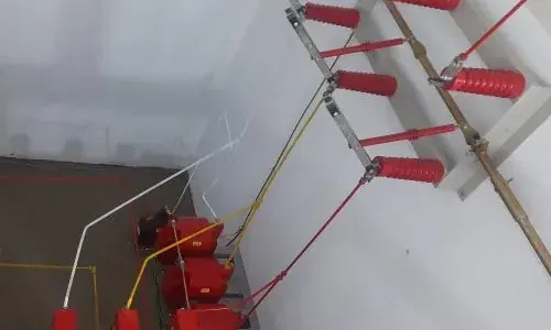 Isoladores e barramentos no interior de uma cabine elétrica